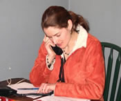 A volunteer works the phones